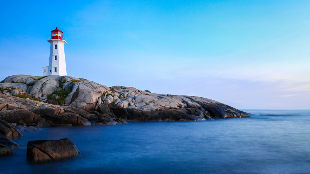 a rocky island in the water - Peggy's Cove lighthouse